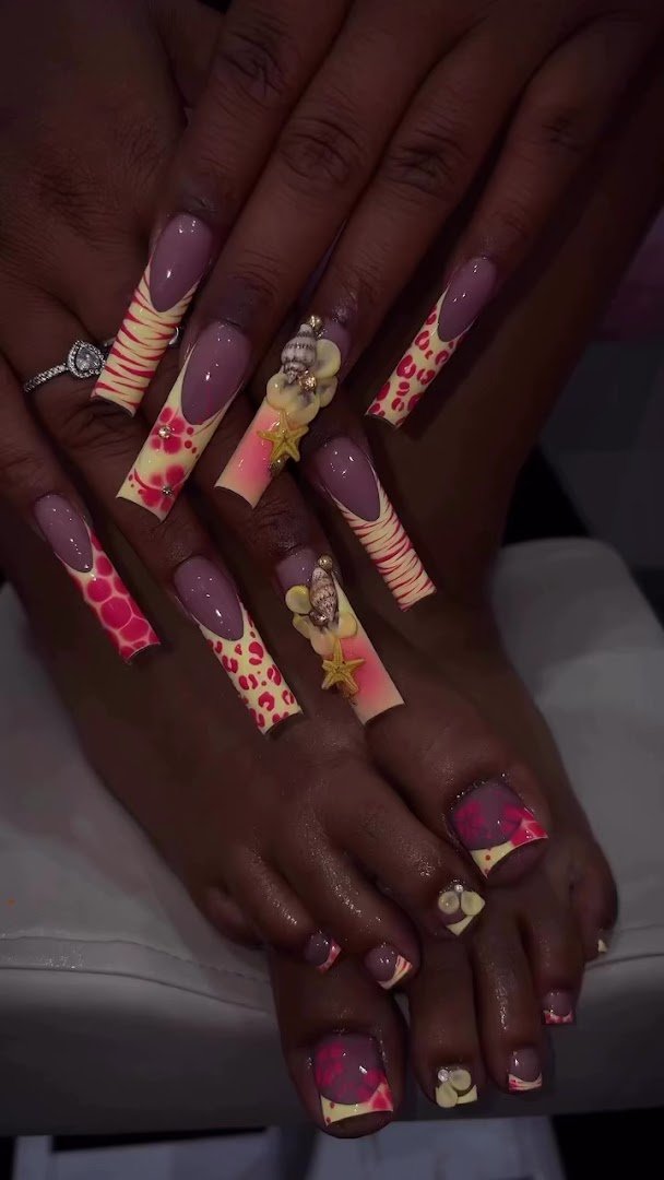 Nail technician shaping nails at a salon table.